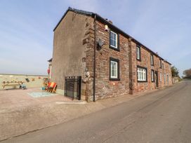 An outdoor area with a house and furniture at Daisy Cottage near Wigton