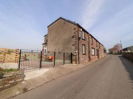 A house with a fence and garden area at Daisy Cottage Near Wigton