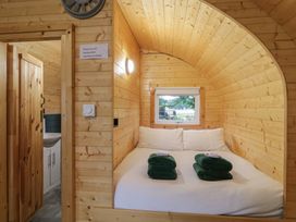 A wooden bedroom with a double bed towels on the bed and a window at Hazel in Dungiven Londonderry