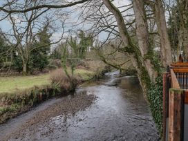 A river flowing under a stone bridge with trees and grass on the banks at Birch in Dungiven Londonderry