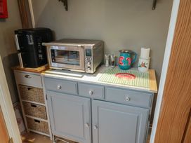 A kitchen with a coffee maker and microwave at Little Sea Thrift in Lyme Regis