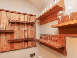 A bar area with shelves displaying wine glasses at Rutland Grange in Filey