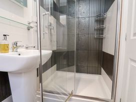 A bathroom with sink and shower at Rutland Grange in Filey