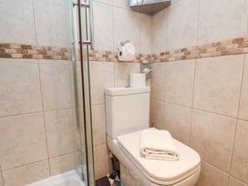 A bathroom featuring a toilet and shower at Rutland Grange in Filey