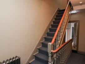 A staircase with a handrail and radiator at Rutland Grange in Filey