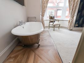 A bathtub in a bathroom at Rutland Grange in Filey