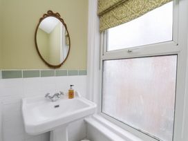 A bathroom with a sink and mirror at Rutland Grange in Filey