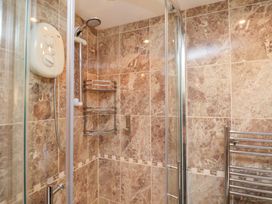 A shower with controls and shelf at Rutland Grange in Filey