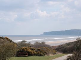 A view of the beach and sea with cliffs in the background at Rutland Grange in Filey