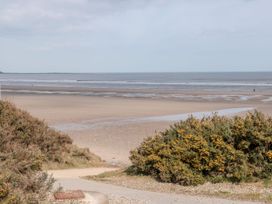 A beach with sand and ocean under a cloudy sky at Rutland Grange in Filey