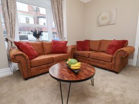 A living room with sofas and a coffee table at Rutland Grange in Filey