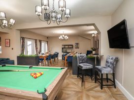 A game room with a pool table and dining area at Rutland Grange in Filey