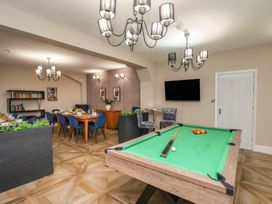 A recreation room with a billiard table and dining area at Rutland Grange in Filey
