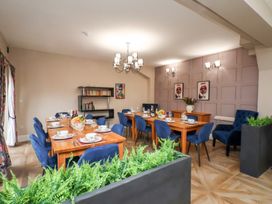 A dining room with tables and chairs at Rutland Grange in Filey