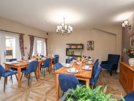 A dining room with a table set for dinner at Rutland Grange in Filey