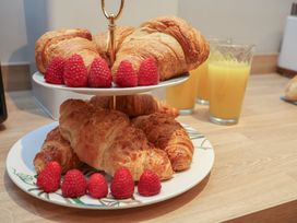 A display of croissants and raspberries with juices in the kitchen at Rutland Grange in Filey