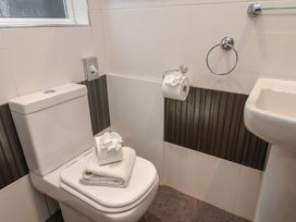 A bathroom with a toilet and sink at Rutland Grange in Filey