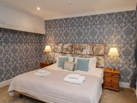 A bedroom with a bed and lamps at Rutland Grange in Filey