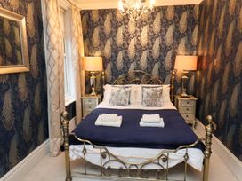 A bedroom with a bed and bedside tables at Rutland Grange in Filey