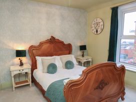 A bedroom with a bed and bedside tables at Rutland Grange in Filey