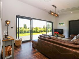A living room with a sofa and a coffee table at Y Cwt in Moelfre
