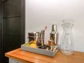 A bar setup with cocktail tools and citrus fruits at Y Cwt Moelfre
