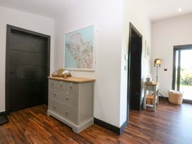 A hallway with a map and dresser at Y Cwt Moelfre