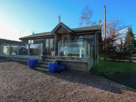 A wooden cabin with glass railing and blue flower pots at Hillview in Stottesdon near Cleobury Mortimer