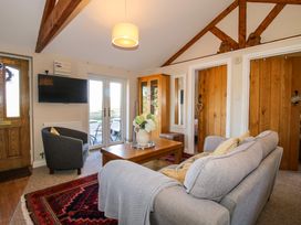 A living room with a sofa armchair coffee table and television at Hillview in Stottesdon near Cleobury Mortimer
