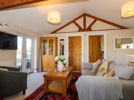 A living room with wooden coffee table sofa armchair and wooden cabinet at Hillview in Stottesdon near Cleobury Mortimer