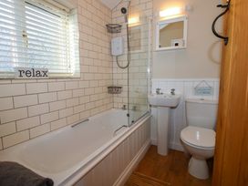 A bathroom with a bathtub shower sink and toilet at Hillview in Stottesdon near Cleobury Mortimer