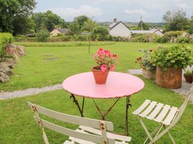 An outdoor area with a table and chairs at Teg in Prospidnick near Porthleven