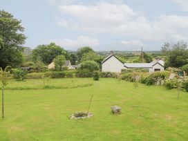 A garden with grass and trees at Teg in Prospidnick near Porthleven