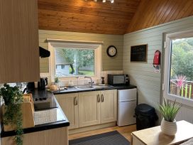 A kitchen with a window and appliances at Number 39 Bodmin
