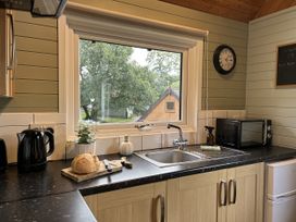 A kitchen with a sink and microwave at Number 39 in Bodmin