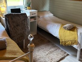 A bedroom with two beds and a desk at Number 39 in Bodmin