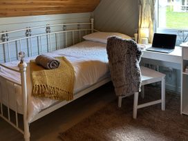 A bedroom with a bed and desk at Number 39 Bodmin