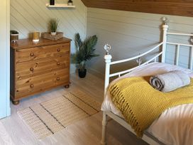 A bedroom with a bed and dresser at Number 39 in Bodmin