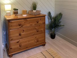 A dresser with a lamp and plants at Number 39 Bodmin
