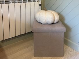 A storage ottoman with a pumpkin on top at Number 39 in Bodmin