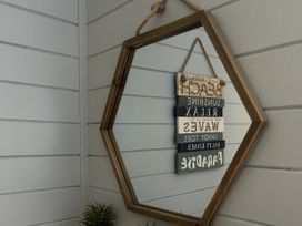 A hexagonal mirror with signs hanging on it at Number 39 in Bodmin