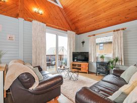 A living room with a sofa and coffee table at Cornish Woodland Retreat Near St Tudy