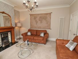 A living room with sofa and coffee table at 11 Rutland Street in Filey