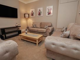 A living room with sofas and a coffee table at 11 Rutland Street in Filey