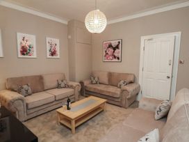 A living room with sofas and a coffee table at 11 Rutland Street in Filey