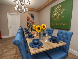 A dining room with a table set for guests at 11 Rutland Street Filey