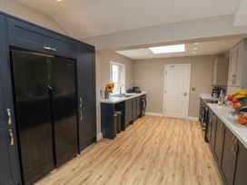 A kitchen with refrigerator and sink at 11 Rutland Street, Filey