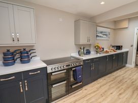 A kitchen with cabinets and appliances at 11 Rutland Street in Filey