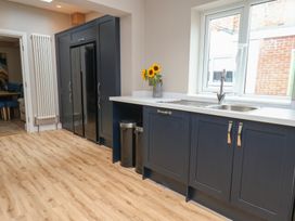 A kitchen with a refrigerator, sink, and cabinet at 11 Rutland Street, Filey