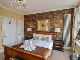 A bedroom with a bed and nightstand at 11 Rutland Street in Filey